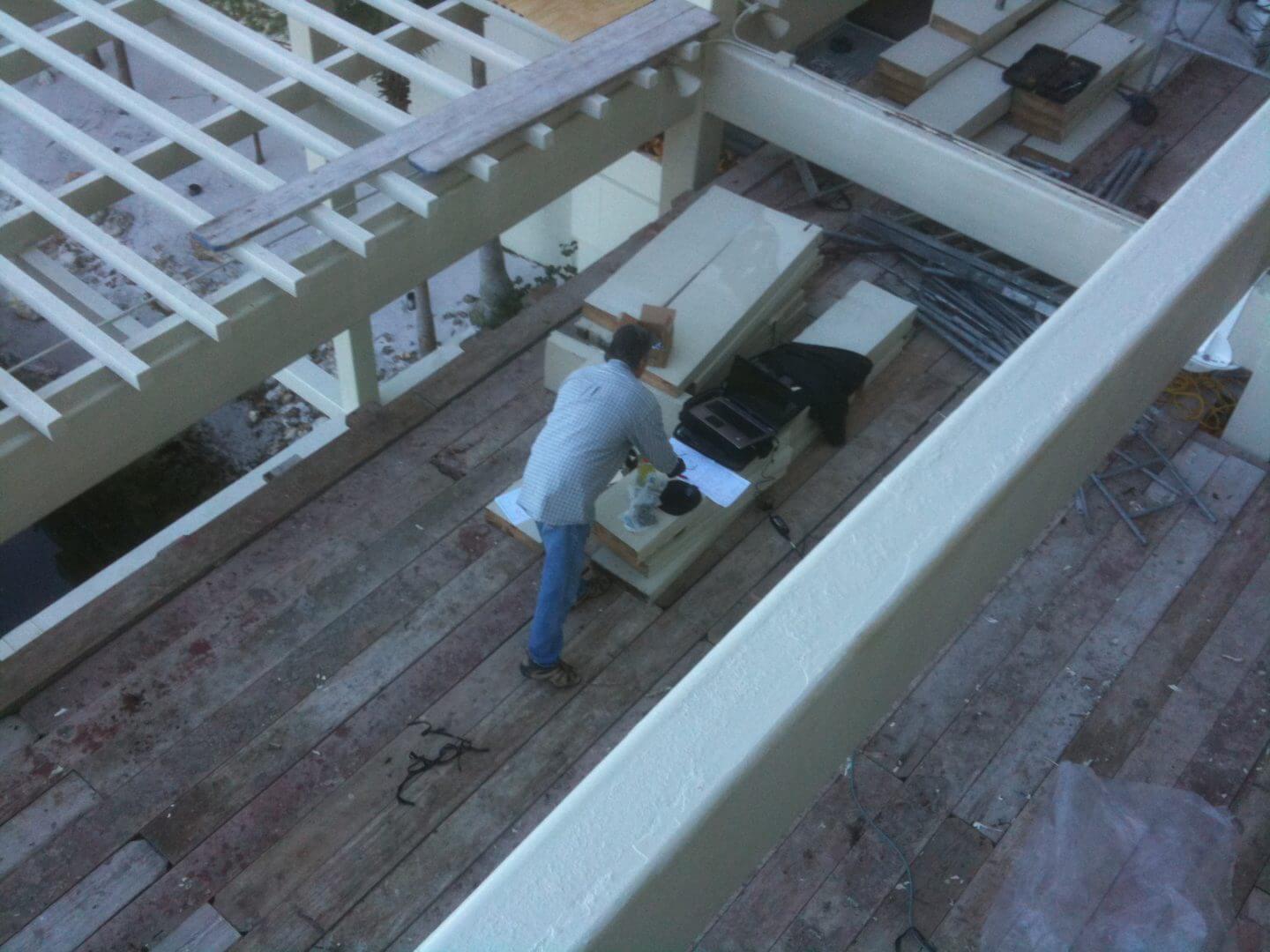 A person working on a rooftop with tools and equipment.