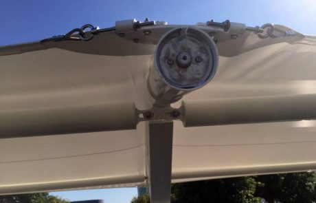 Security camera mounted on a building under clear blue sky.