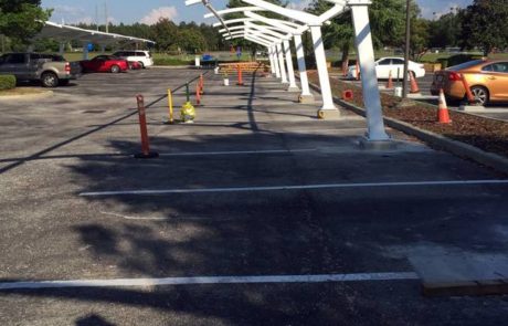 White metal structure in parking lot under construction.