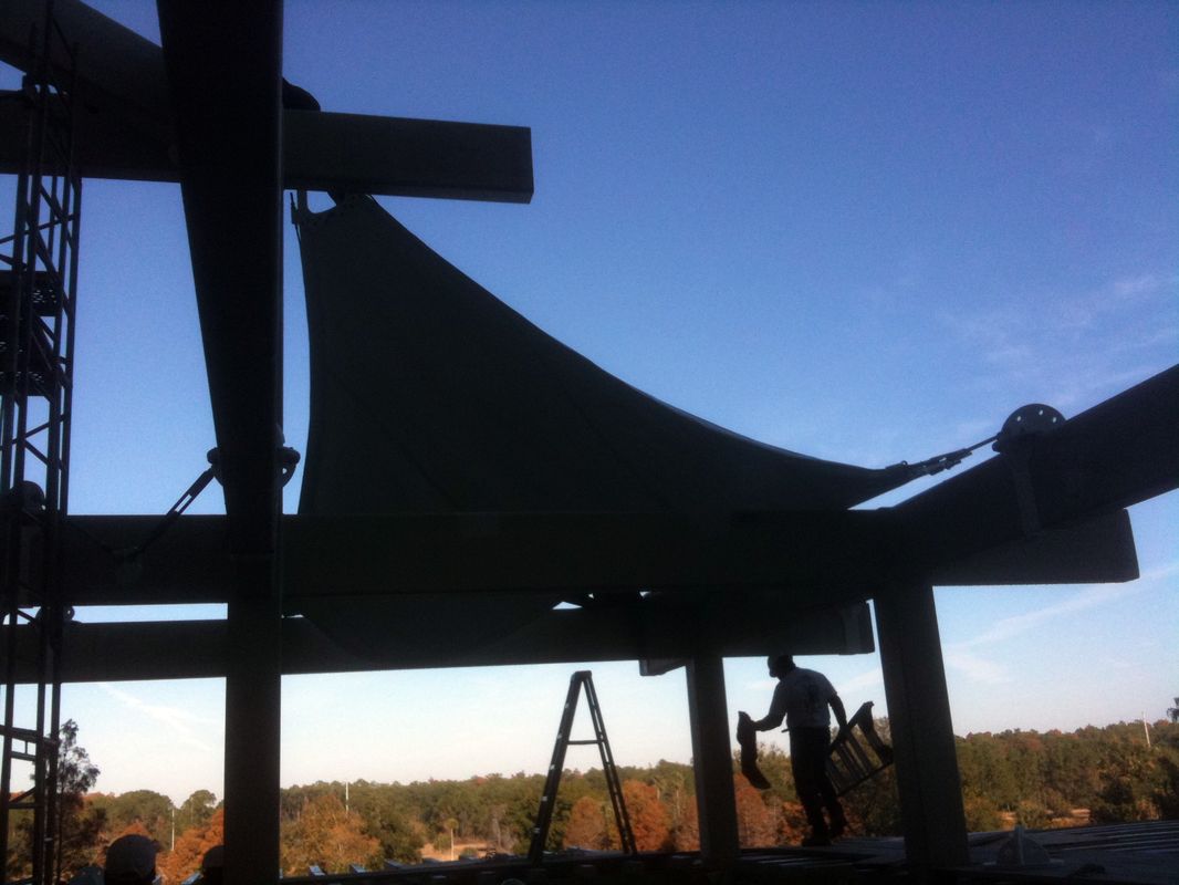 Silhouetted patio structure against a clear blue sky at sunset.