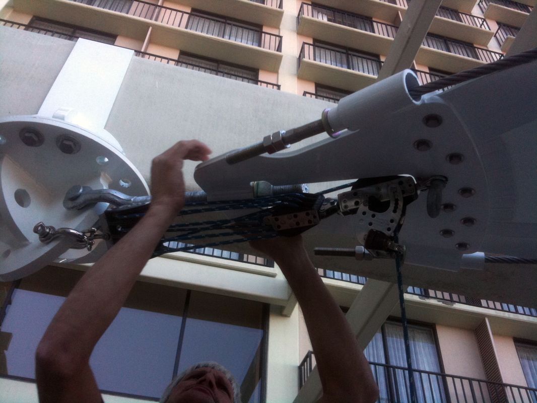 Person mounting a large drone or aircraft component outdoors.