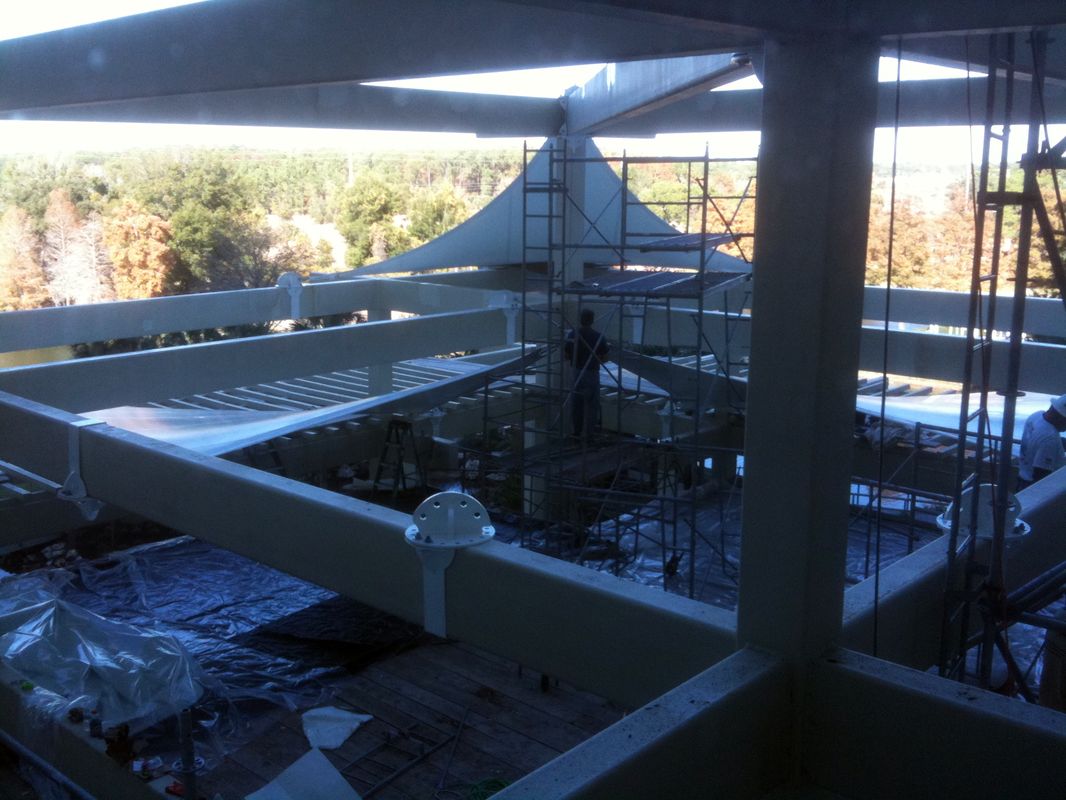 Construction site with scaffolding and structural beams under daylight.