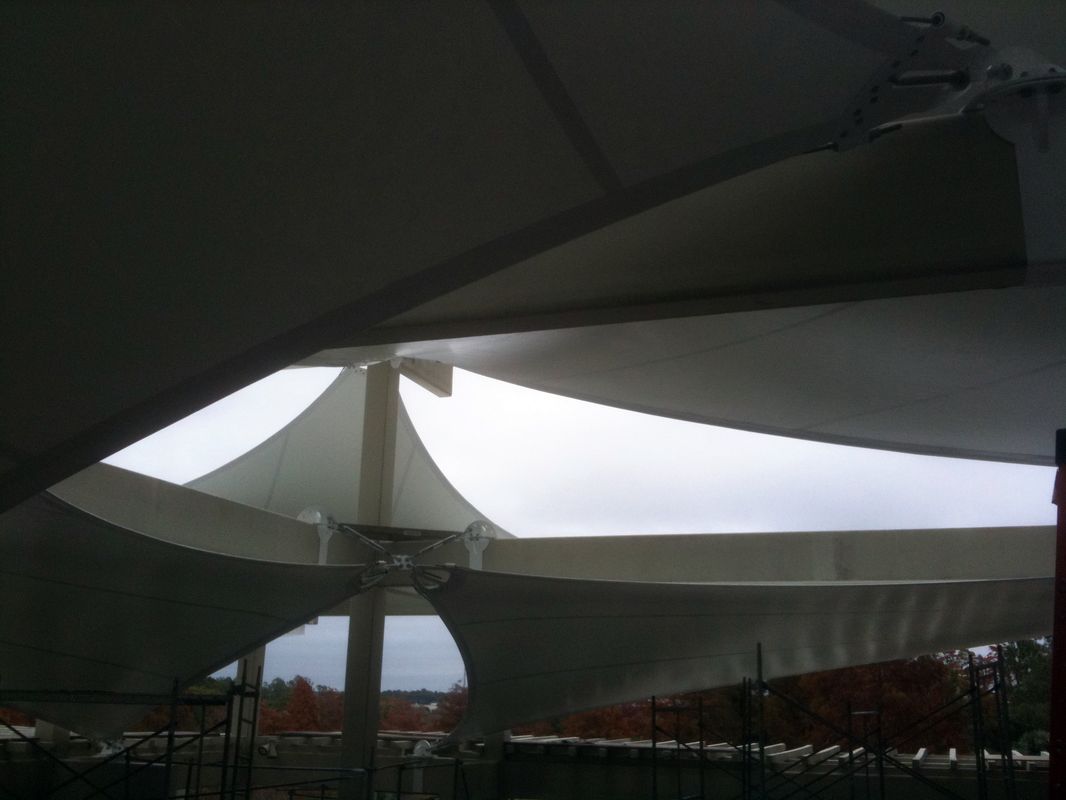 Modern architectural structure with curved roof and supporting columns.