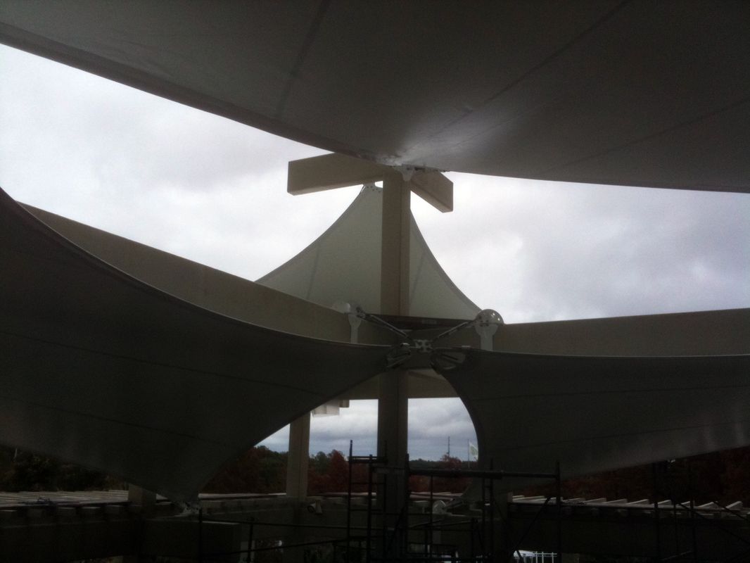 Modern architectural structure under a cloudy sky.