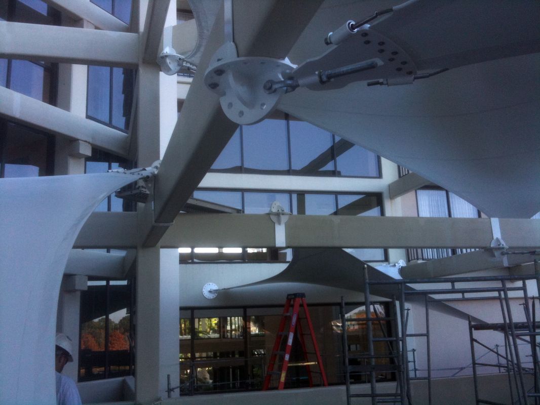 Construction site with metal beams and scaffolding inside a building.
