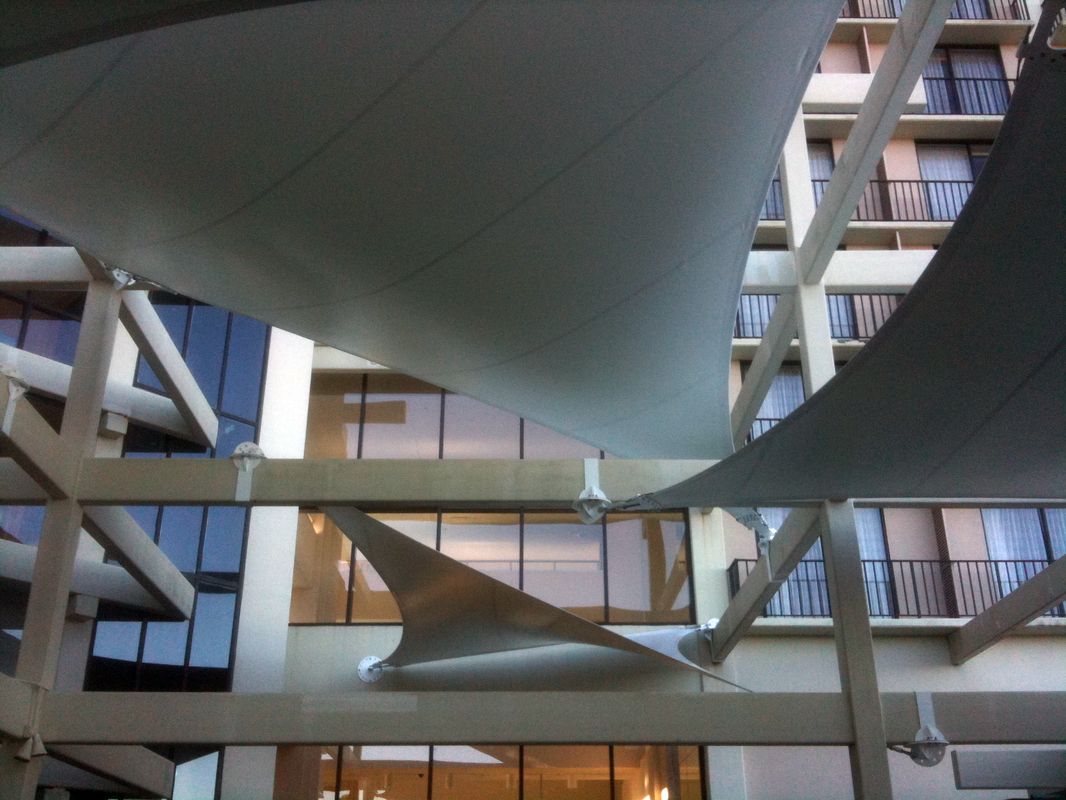 Modern architectural sails hanging inside a building atrium.