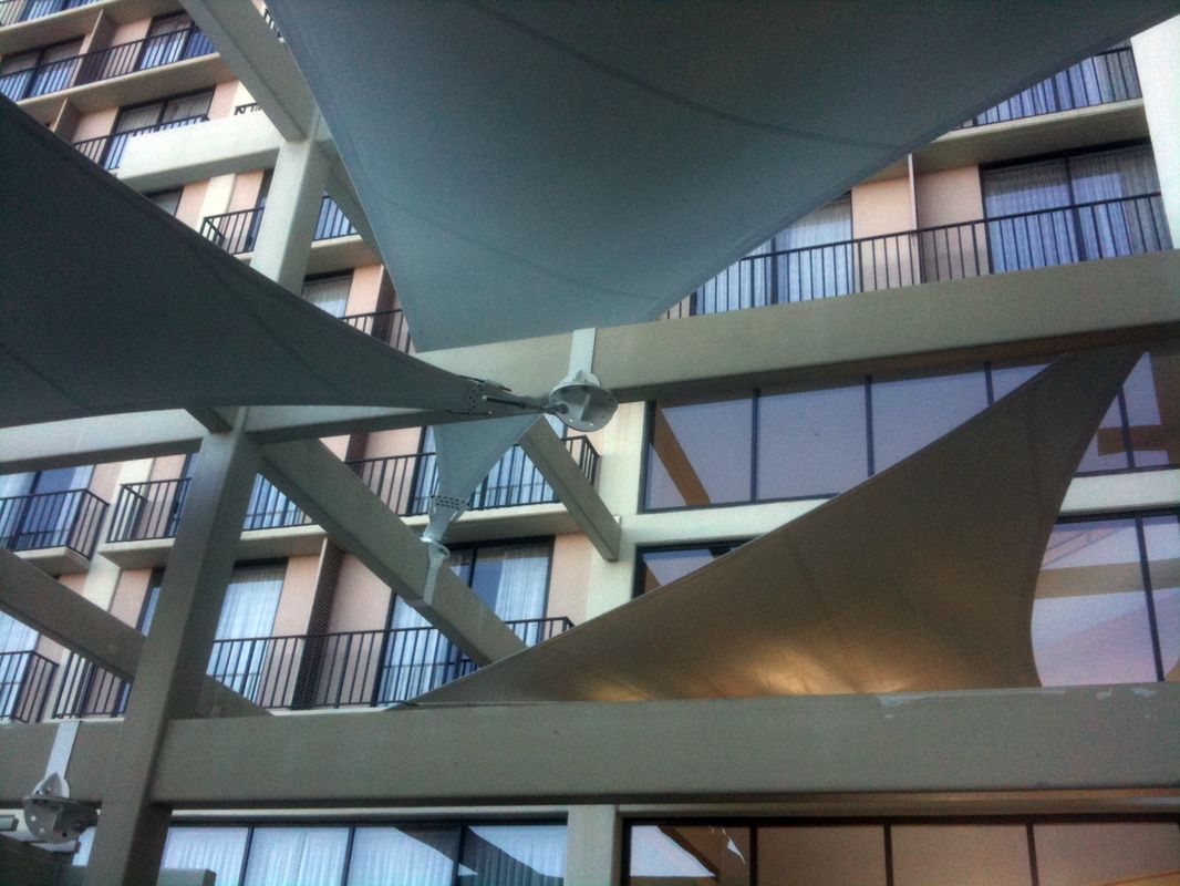 Architectural design of triangular sails in a building courtyard.